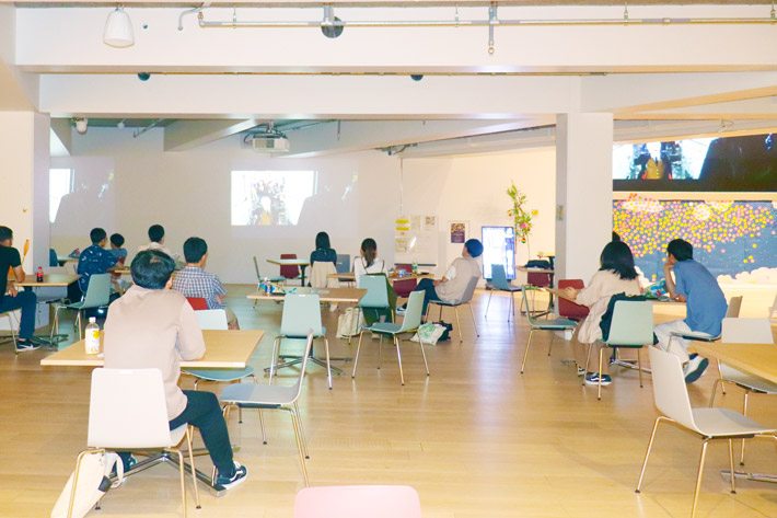 Participants watching film in Taki Plaza's Event Space
