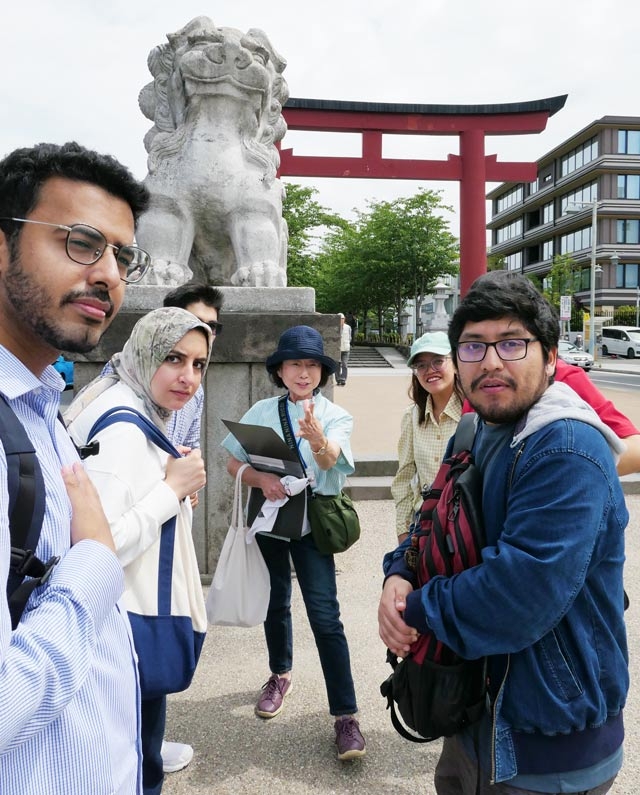Students listening to local guide at second <i>torii</i> gate