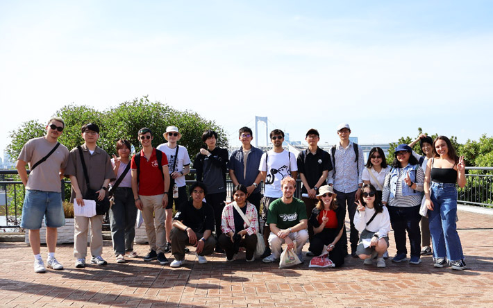 Walking tour participants with Tokyo's Rainbow Bridge in background