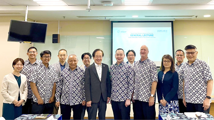 Masu (center left) at Sampoerna University with Sampoerna Schools System CEO Irawan (center right), President Schott (4th from right), Rector Yudhi (5th from left), and others